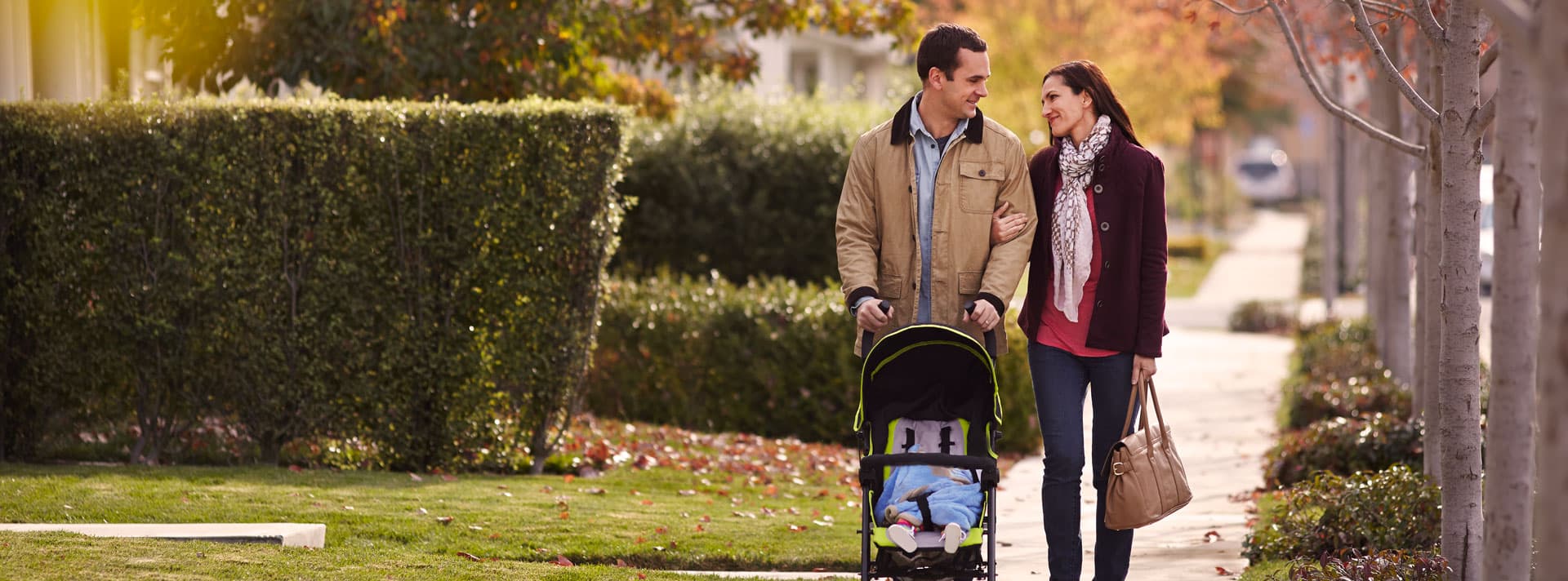 Couple walking with baby stroller