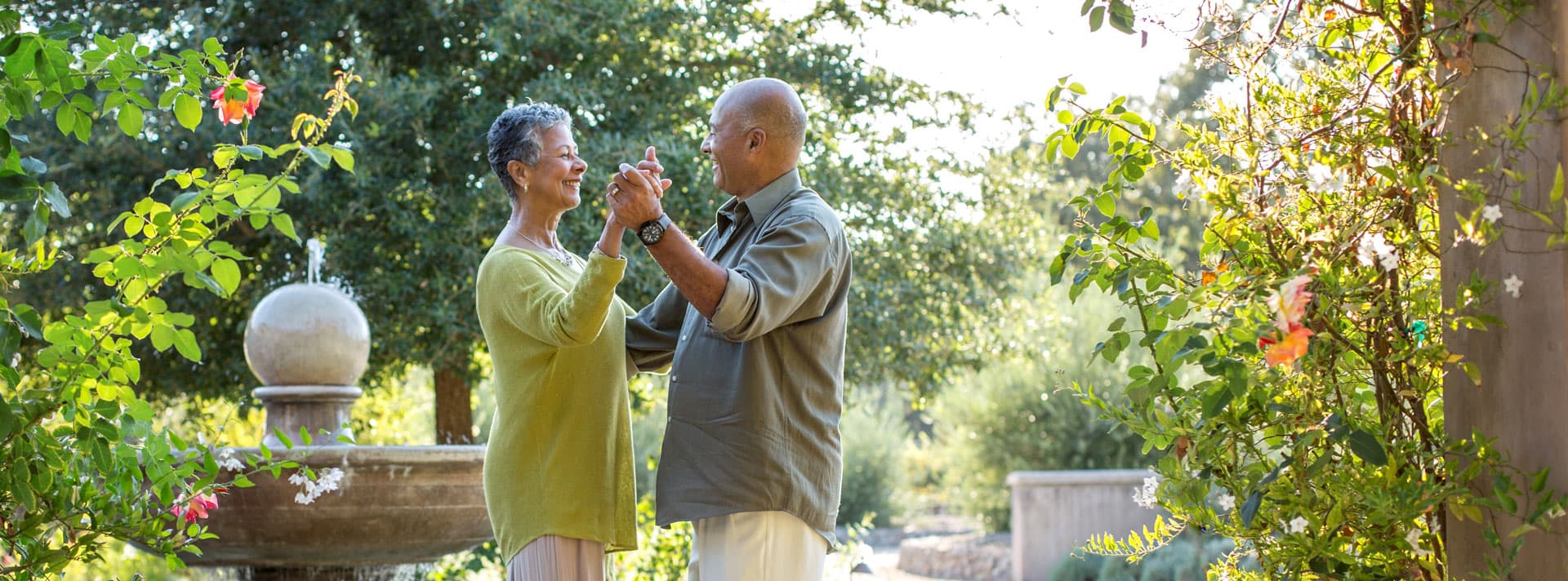 Senior couple dancing in a garden